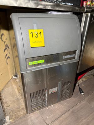 an image of a refrigerator that has a yellow sticker on it