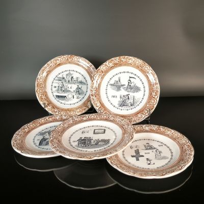 three plates with different designs on them sitting on a table