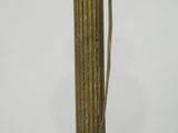 tall brass vase with a long stem and a flower on top of it