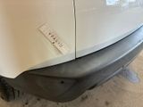 a sticker on the bumper of a car that has been dented