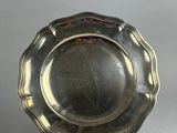 silver plate on stand on grey background with white background