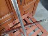 a knife stuck in a wooden crate on the floor