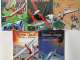 several children ' s books are lined up on a white surface