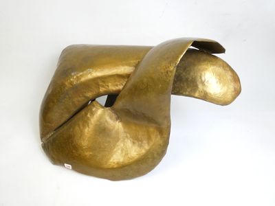 brass sculpture of a bird ' s head on a white surface