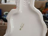 an image of a close up of a white vase with a horse on it