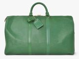 a green duffel bag sitting on top of a white surface
