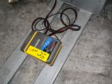 a yellow and black device sitting on the ground