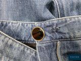 the back pocket of a pair of jeans with a button on it