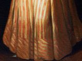 portrait of a woman in a striped dress holding a fan