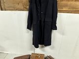 several pieces of luggage and a coat hang on a wall