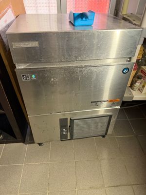a stainless steel refrigerator in a kitchen next to a window
