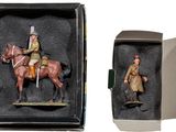 two figurines of a man riding a horse in a box