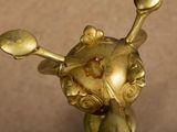 a gold figurine of a skull and crossbones on top of it