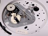a close up of a clock with a metal mechanism