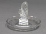 a clear glass object with a bird on top of it