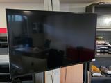 a large flat screen tv sitting on a stand in a room