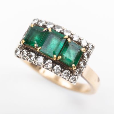 an image of a close up of a ring with three emerald stones