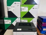 a printer sitting on top of a table next to a stack of boxes