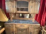 a large wooden cabinet with a mirror on top of it