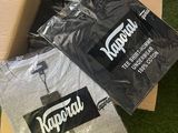 a box of t - shirts and a pair of shoes on the grass