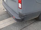 a grey van parked on the side of the street