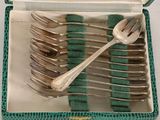 silverware in a green box with a spoon and fork inside