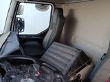 a view of the inside of a truck from the driver ' s seat