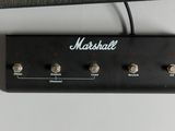 a guitar amp sitting on a table next to a wall