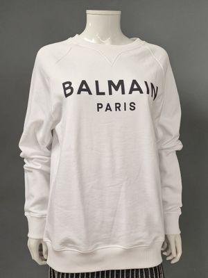 a white sweatshirt with the word balmain paris printed on it