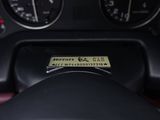 a close up of a steering wheel with a sticker on it