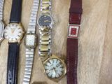 a lot of watches that are sitting on a table