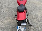 a red motorcycle that is parked in a lot