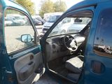 a small blue car with its door open in a parking lot