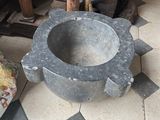 a stone bowl sitting on the floor in a room