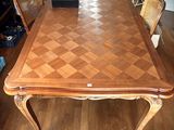 a large wooden table with chairs around it in a living room