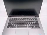 an open laptop computer sitting on top of a white table