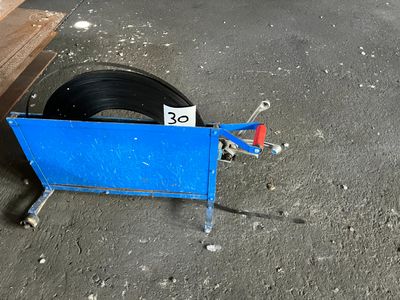 a tire on the ground next to a blue cart