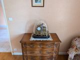 a small table with a clock on top of it in a living room