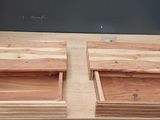 a close up of a wooden table with two drawers on it