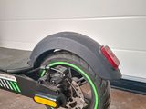 a scooter that is parked in front of a garage door