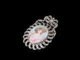 une photo d'une broche sur laquelle figure le portrait d'une femme