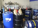 de nombreux fûts de différentes tailles et couleurs entreposés dans un garage