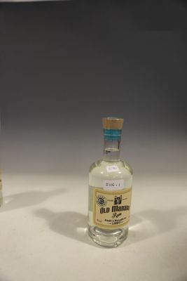 two small bottles of alcohol sitting on a table