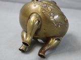 brass figurine of an elephant with flowers on it ' s back