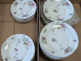 many plates in a box that are sitting on a table