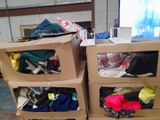 several boxes of clothing are stacked on top of each other in a room