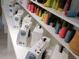 many spools of thread on the shelves in the sewing room