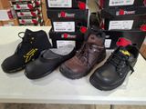 several pairs of work boots are lined up on a table