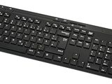 a computer keyboard and a mouse on a white surface
