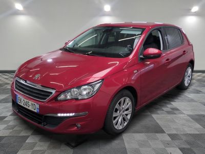 la voiture rouge est garée sur un sol en damier dans le garage